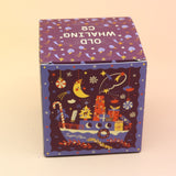 The Sugar Plum Ferry Holiday Bath Bomb in front of a pink and yellow background, showing off the side.