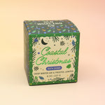 The Coastal Christmas Holiday Bath Bomb in front of a pink and yellow background.