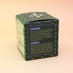 The Coastal Christmas Holiday Bath Bomb in front of a pink and yellow background, showing off the side.