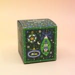 The Coastal Christmas Holiday Bath Bomb in front of a pink and yellow background, showing off the back.