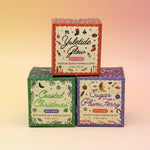 The three Old Whaling holiday bath bombs on a pink and yellow background.