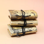 Three of the Lotions & Potions Mini Journals on a pink and yellow background.