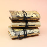 Three of the Lotions & Potions Mini Journals on a pink and yellow background.