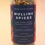 The Mulling Spices bottle on a pink and yellow background.