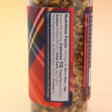 The Mulling Spices bottle on a pink and yellow background.