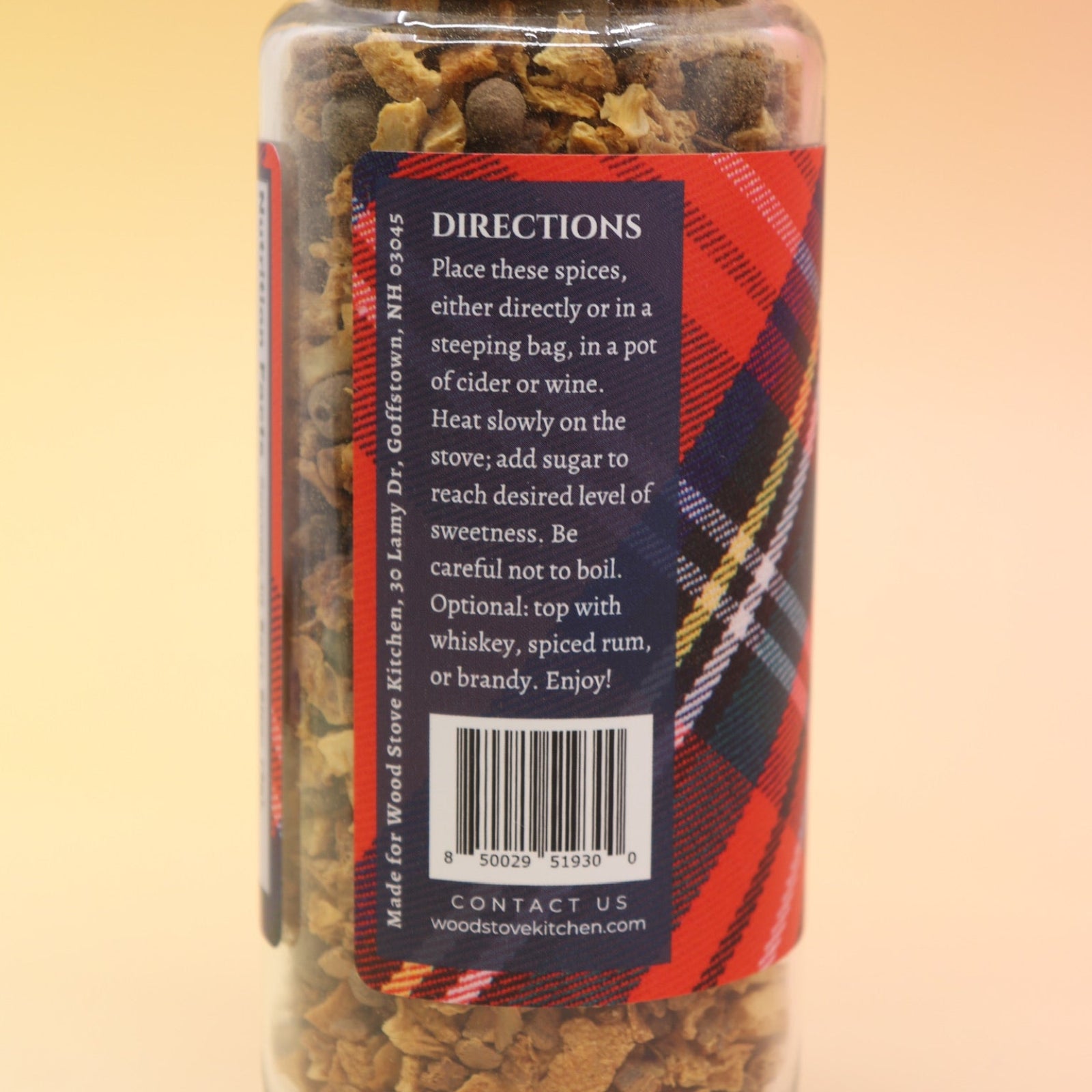 The Mulling Spices bottle on a pink and yellow background.