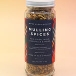 The Mulling Spices bottle on a pink and yellow background.
