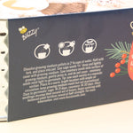 The back of the Holiday Hammered Windowsill Rosemary & Sage Growing Kit on a pink and yellow background.