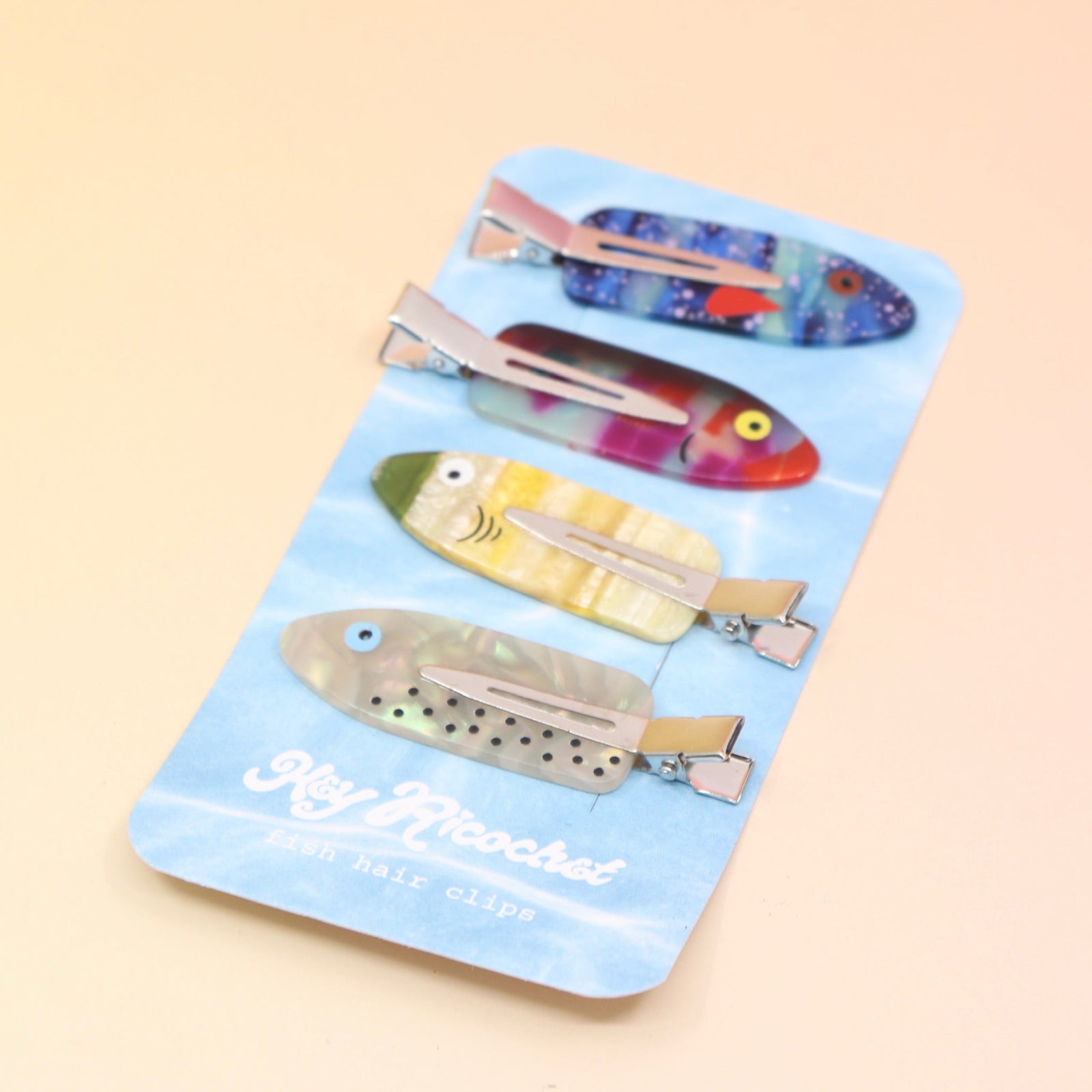 The Tackle Box Fish Clip Set on a pink and yellow background.