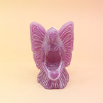 The purple Fairy Candle on a pink and yellow background.