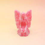 The pink Fairy Candle on a pink and yellow background.