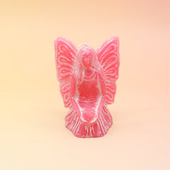 The pink Fairy Candle on a pink and yellow background.