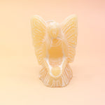 The yellow Fairy Candle on a pink and yellow background.