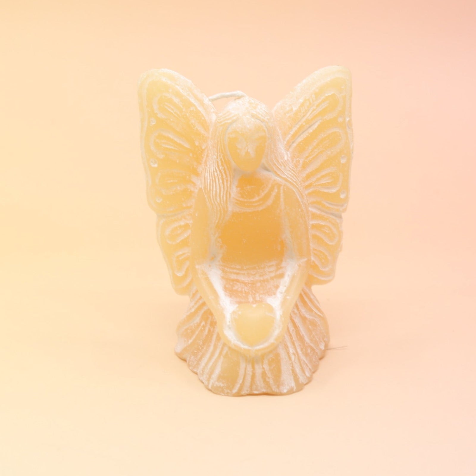 The yellow Fairy Candle on a pink and yellow background.