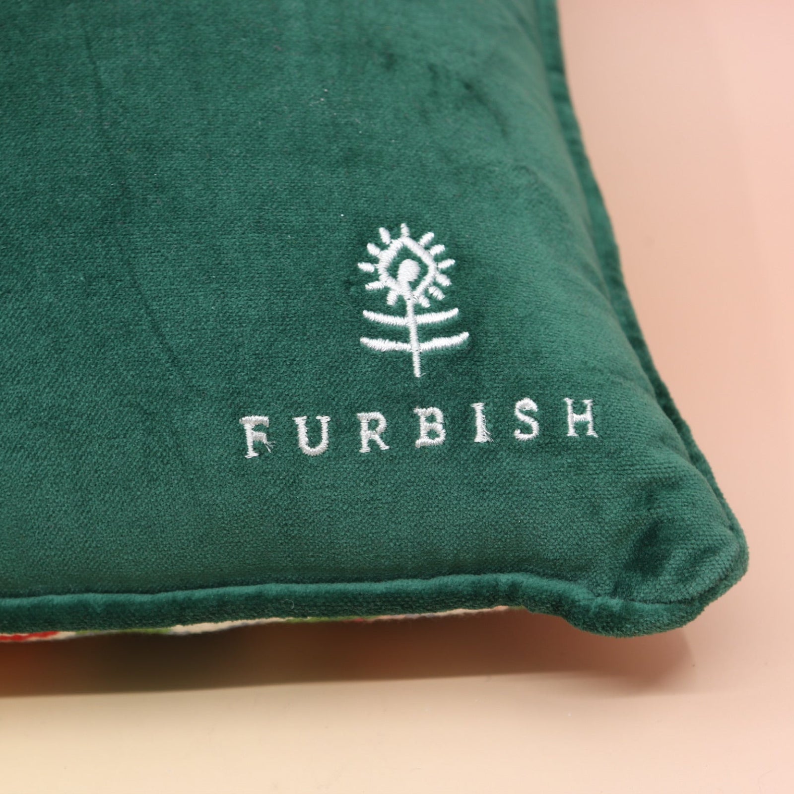 The Bless Your Heart Needlepoint Pillow on a pink and yellow background, showing off the back.