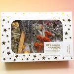 The DIY Smoke Cleansing Smudge Kit on a pink and yellow background.