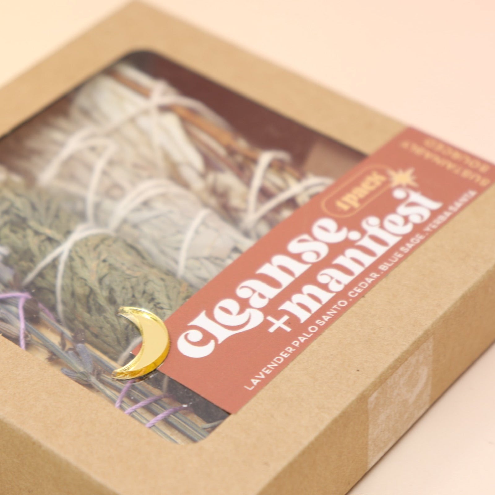 The Cleanse & Manifest Smudge Bundle Kit on a pink and yellow background.