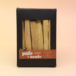 The 6 Pack Palo Santo Cleansing Bundle on a pink and yellow background.