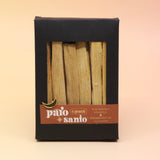 The 6 Pack Palo Santo Cleansing Bundle on a pink and yellow background.