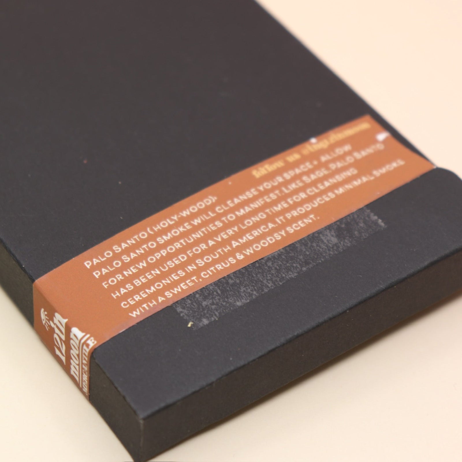 The 6 Pack Palo Santo Cleansing Bundle on a pink and yellow background, showing off the back.