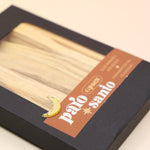 An up-close image of the 6 Pack Palo Santo Cleansing Bundle on a pink and yellow background.