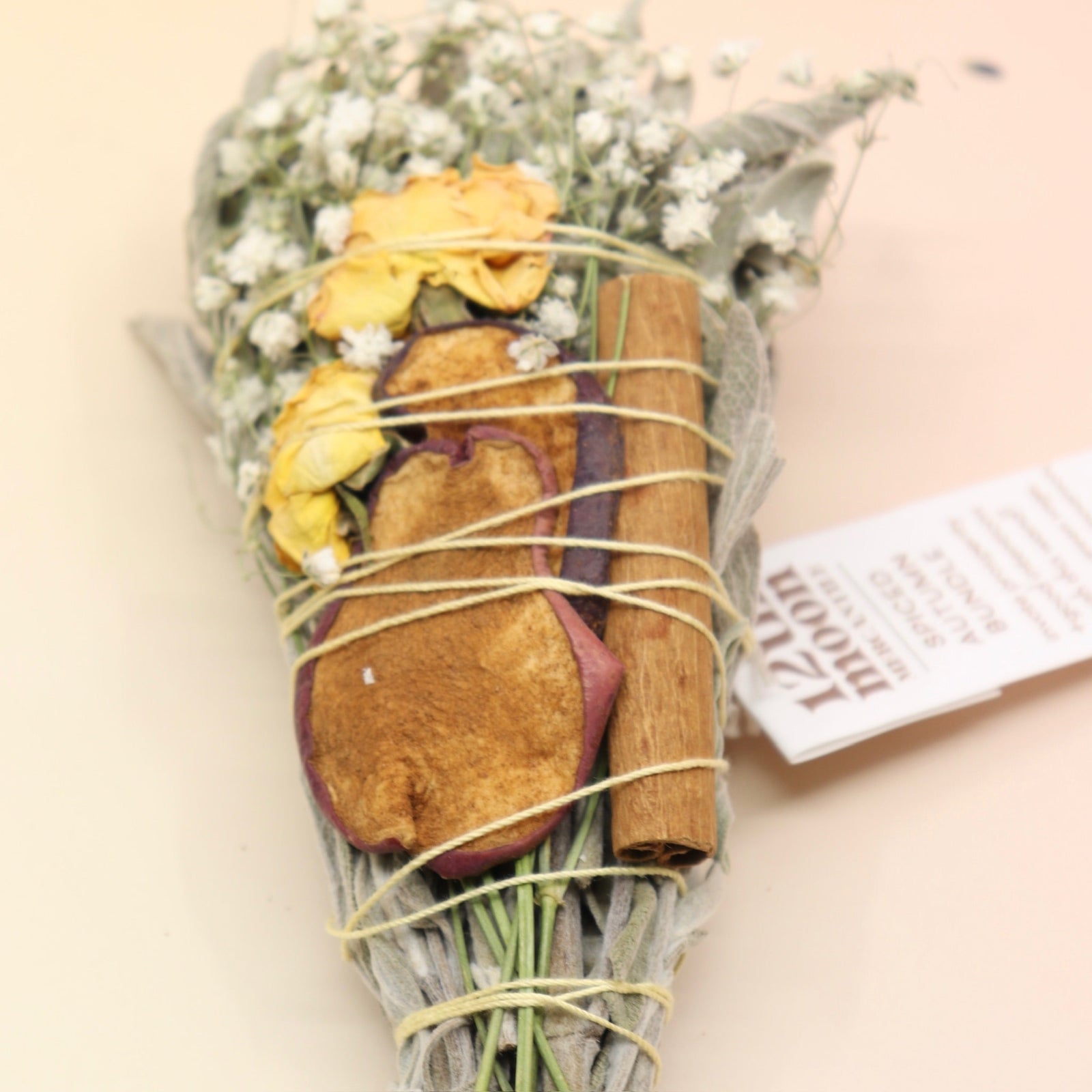 The Spiced Autumn Cleansing Smudge Bundle on a pink and yellow background.