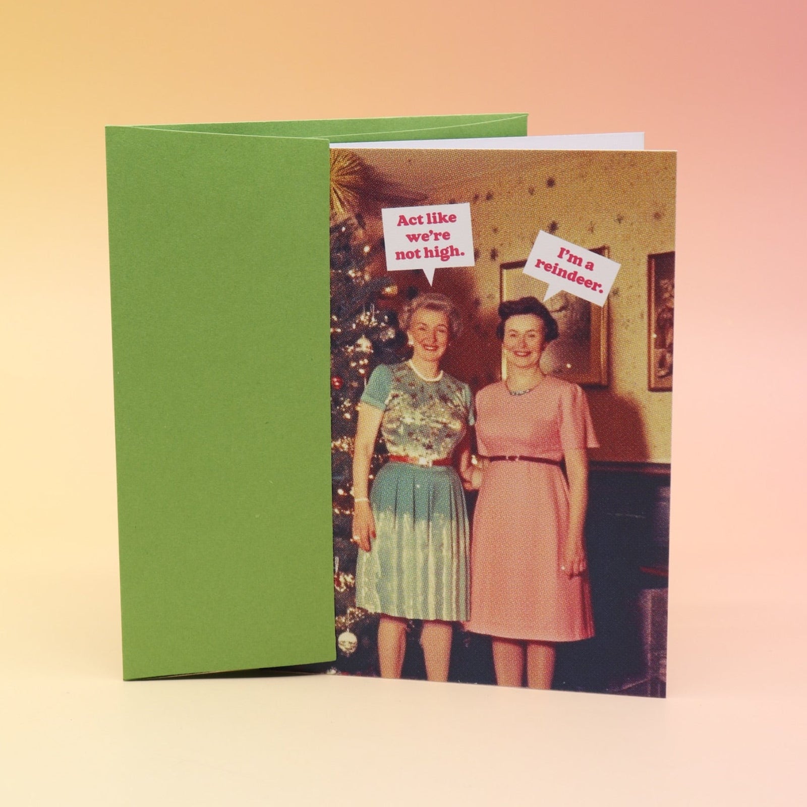 The Act Like We're Not High Christmas Card with its envelope on a pink and yellow background.