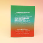 The back of the Have a Serene Christmas Card on a pink and yellow background.