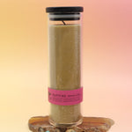 The Rapture Beeswax Aromatherapy Sanctuary Glasses on an agate slice all on a pink and yellow background.