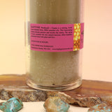 The Rapture Beeswax Aromatherapy Sanctuary Glasses on an agate slice all on a pink and yellow background.