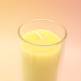 The Awaken Beeswax Aromatherapy Sanctuary Glasses on an agate slice all on a pink and yellow background.