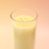 The Awaken Beeswax Aromatherapy Sanctuary Glasses on an agate slice all on a pink and yellow background.