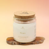 The large Peace Intention Candle on an agate slice all on a pink and yellow background.