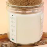 An up-close image of the Peace Intention Candle on an agate slice all on a pink and yellow background.