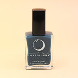 The Eternal Student Nail Polish on a pink and yellow background.