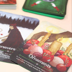 The contents of the Seasons of the Witch Yule Oracle Card Deck on a pink and yellow background.