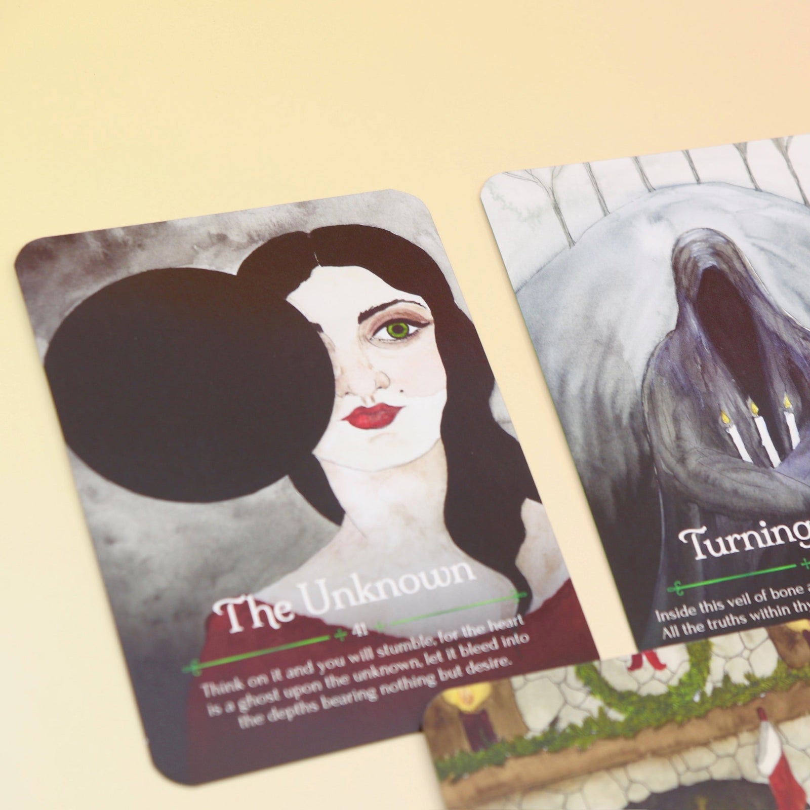 The contents of the Seasons of the Witch Yule Oracle Card Deck on a pink and yellow background.