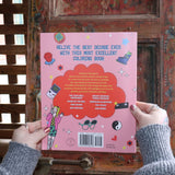 Someone holding the 1990s Coloring Book in front of a wooden background, showing off the back.