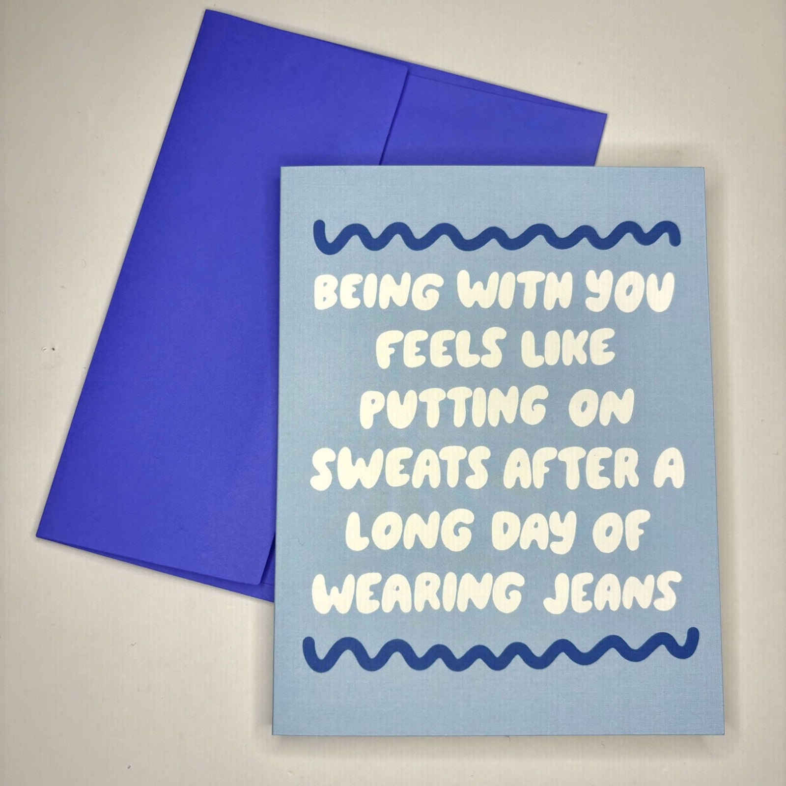 The Putting On Sweats Love Card on a gray background.