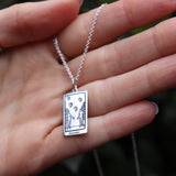 Someone holding the The Lovers Tarot Sterling Silver Necklace.