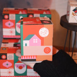 Someone holding the Geometric Santa Bath Bomb in front of other bath bombs, showing off the side.