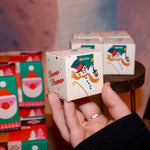 Someone holding the Snow Shower Steamer in front of other shower steamers.