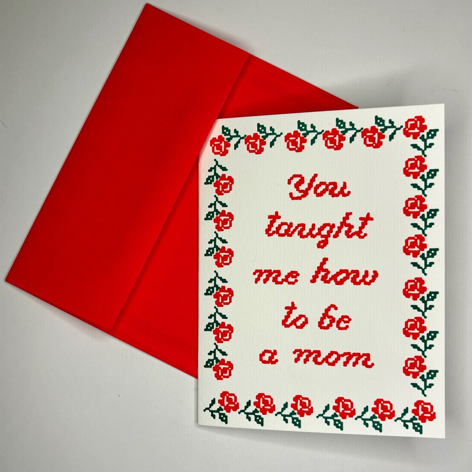 The You Taught Me How To Be a Mom - Greeting Card on a gray background.