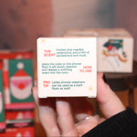 Someone holding the Snow Shower Steamer in front of other shower steamers, showing off the back.