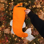 Someone holding the Felt Japanese Koi Fish Christmas Stocking in front of a Christmas tree, showing off the back.