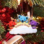 The Grateful Dead Three Bears On A Cloud Ornament hanging on a Christmas tree.