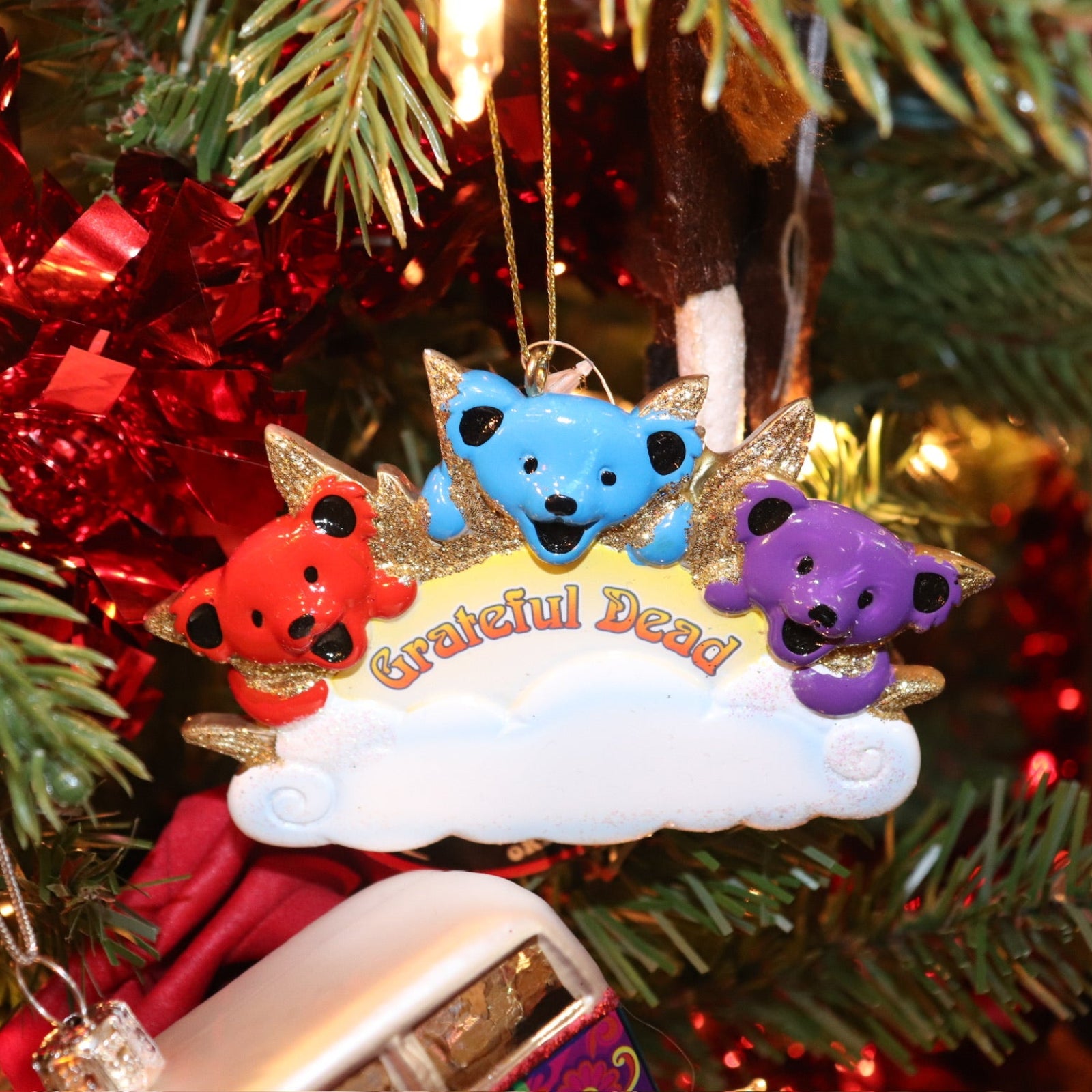 The Grateful Dead Three Bears On A Cloud Ornament hanging on a Christmas tree.