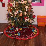 The All Is Bright Embroidered Tree Skirt around the bottom of a tree.