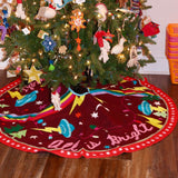 The All Is Bright Embroidered Tree Skirt around the bottom of a tree.