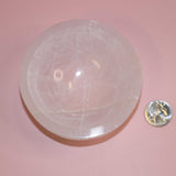 selenite crystal bowl on pink backdrop